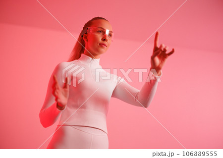 Woman in smartglasses against red background 106889555