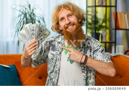 Successful happy rich business man counting money cheering up with high profits, lottery game win Successful happy rich business man counting money cheering up with high profits, lottery game win 106889649