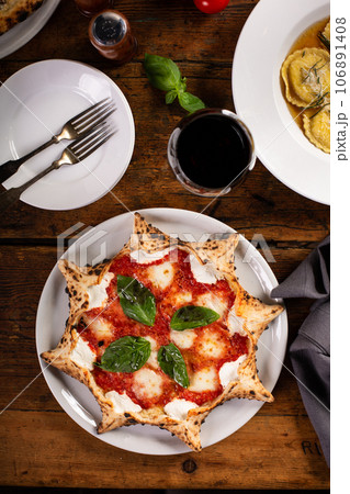 Freshly baked carnival pizza margarita with fresh basil 106891408