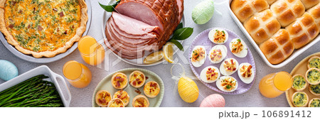 Easter brunch table with ham, quiche, hot cross buns Easter brunch table with ham, quiche, hot cross buns 106891412