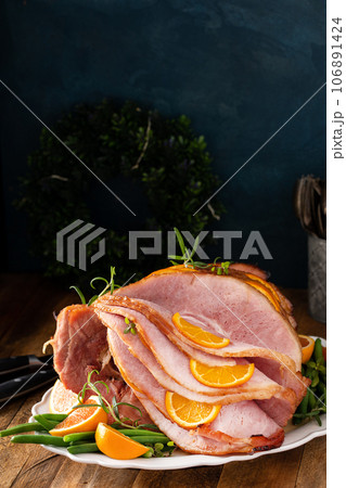 Christmas honey glazed ham served on a plate Christmas honey glazed ham served on a plate 106891424