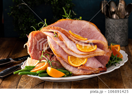 Christmas or Thanksgiving spiral sliced ham with oranges and herbs Christmas or Thanksgiving spiral sliced ham with oranges and herbs 106891425