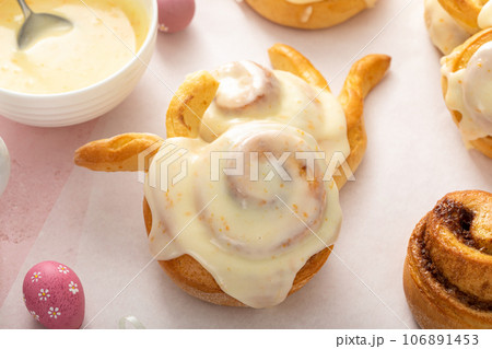 Easter breakfast rolls with orange glaze shaped like a bunny Easter breakfast rolls with orange glaze shaped like a bunny 106891453