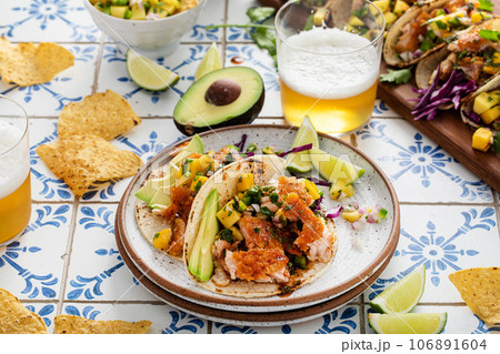 Fish tacos with mango salsa and red cabbage 106891604