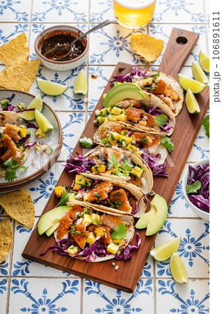 Fish tacos with mango salsa and red cabbage Fish tacos with mango salsa and red cabbage 106891611
