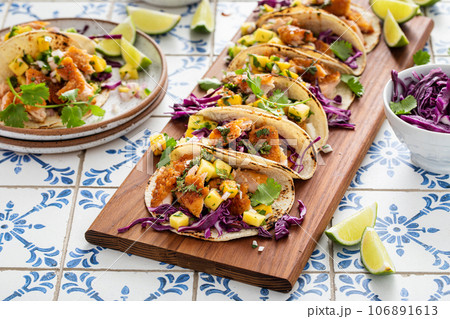 Fish tacos with mango salsa and red cabbage Fish tacos with mango salsa and red cabbage 106891613