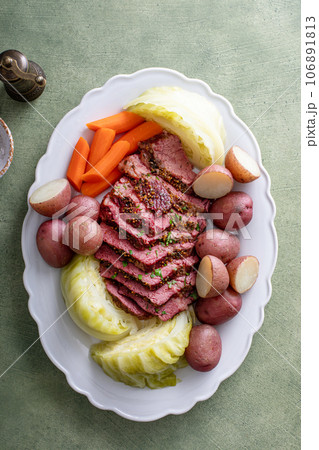 Corned beef with cabbage and potatoes on a serving platter 106891813