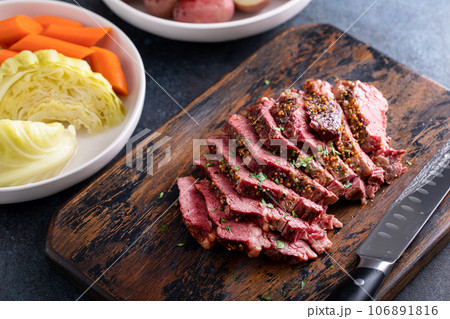 Corned beef cooked and sliced on a cutting board 106891816