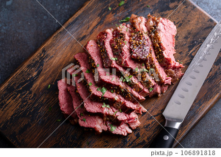 Corned beef cooked and sliced on a cutting board 106891818