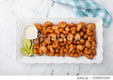 Coconut shrimp with ranch dip and lime wedges Coconut shrimp with ranch dip and lime wedges 106891884