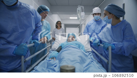 Mom supports lying on gurney kid before operation Mom supports lying on gurney kid before operation 106892510