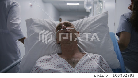 Patient with breathing tube tries to sleep on gurney after operation 106892593