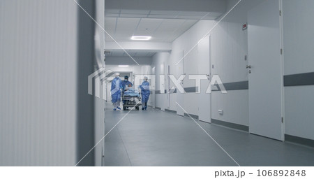 Doctors run and push gurney with injured patient Doctors run and push gurney with injured patient 106892848