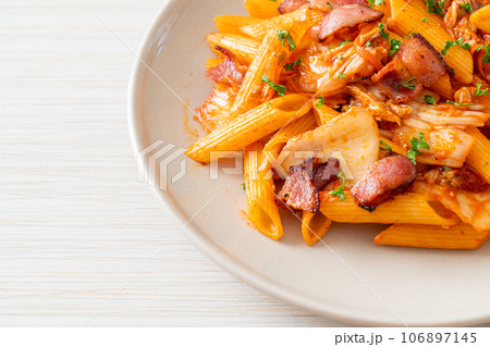 stir-fried penne pasta with kimchi and bacon stir-fried penne pasta with kimchi and bacon 106897145