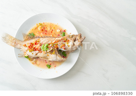 Steamed grouper fish with lime and chillies Steamed grouper fish with lime and chillies 106898330