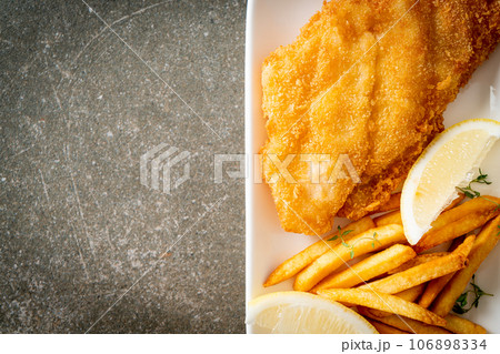 fish and chips - fried fish fillet with potatoes chips 106898334