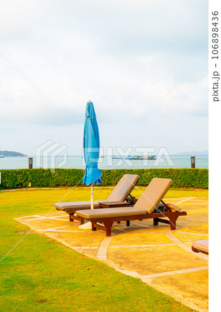 chair pool or bed pool and umbrella around swimming pool with sea beach background 106898436