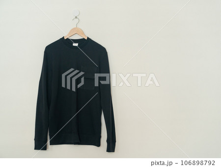 black sweater hanging on hanger black sweater hanging on hanger 106898792
