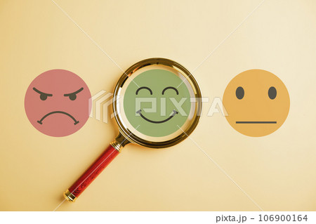 Seeking happiness smiley face icon under magnifying glass. Customer satisfaction and evaluation or marketing survey. Magnification, satisfaction, reputation, corporate, customer, emotion portrayed. 106900164
