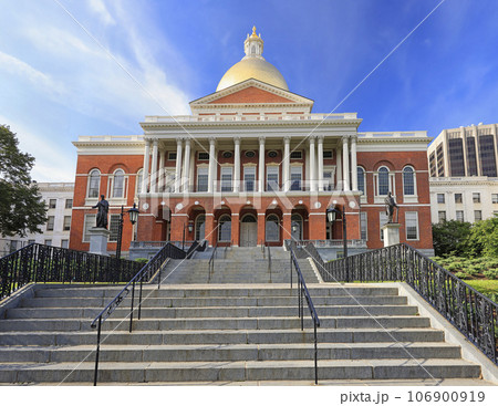 Massachusetts State House and State Library. Imposing red building with white columns and golden dome.  106900919