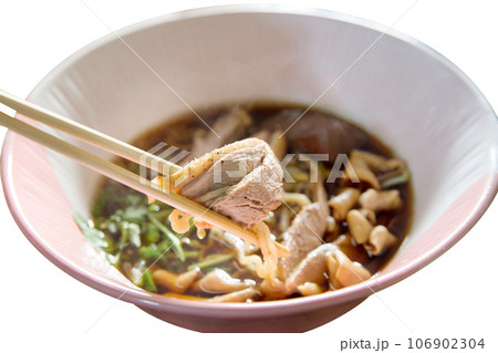 Top view of Duck noodle on a pink bowl with chopsticks on white isolated, focus selective Top view of Duck noodle on a pink bowl with chopsticks on white isolated, focus selective 106902304