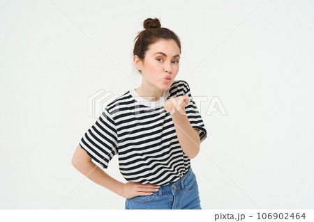 Portrait of cute young woman blows air kiss, sends mwah at camera, posing cute against white background. Lifestyle and people concept Portrait of cute young woman blows air kiss, sends mwah at camera, posing cute against white background. Lifestyle and people concept 106902464