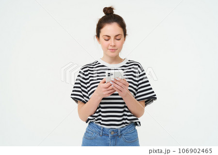 Technology and lifestyle. Young woman standing over white background with smartphone Technology and lifestyle. Young woman standing over white background with smartphone 106902465