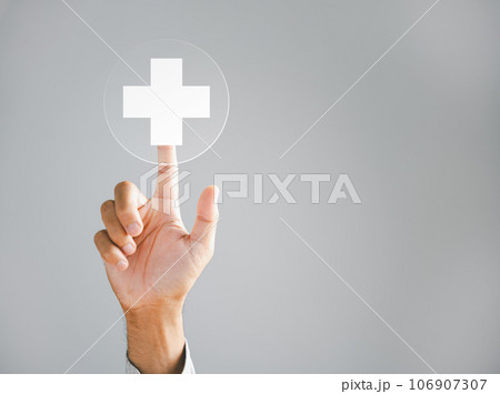 Businessman hand taps a virtual plus sign, representing positivity. Conveys ideas of increased benefits, progressive thinking, and a positive mindset. Business and success concept. positive thing 106907307