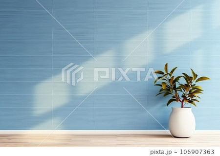 plant against a blue wall background with copy space 106907363