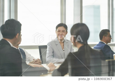 young asian business woman laughing during team meeting in office 106908367