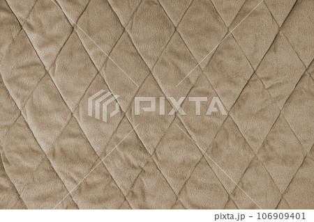 Quilted gray velours fabric background, wrinkled soft blanket surface Quilted gray velours fabric background, wrinkled soft blanket surface 106909401