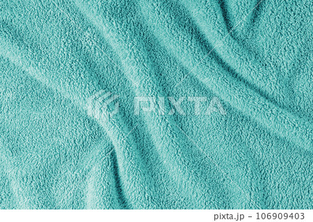 Terry cloth, turquoise towel texture background. Soft fluffy textile bath or beach towel material Terry cloth, turquoise towel texture background. Soft fluffy textile bath or beach towel material 106909403
