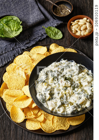 artichoke spinach almond dip with potato chips 106910119