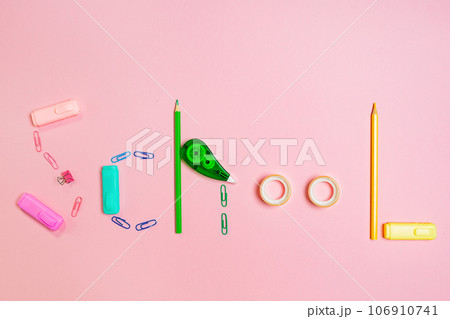 Back to school concept. The inscription is made up of multi-colored stationery. Pink background. Flat lay 106910741