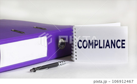 Notepad with Compliance text, on white background with folder and pen 106912467