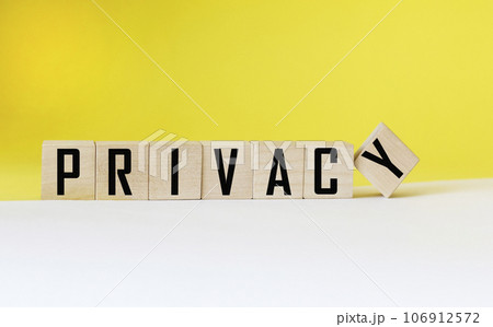 Privacy word on wooden cube and white and yellow background. Privacy word on wooden cube and white and yellow background. 106912572