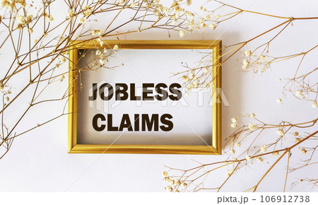 Jobless claims, text drawn on a photo frame with a white 106912738