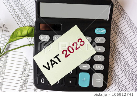 Calculator, documents and reports and a sticker with the text VAT 2023 Calculator, documents and reports and a sticker with the text VAT 2023 106912741