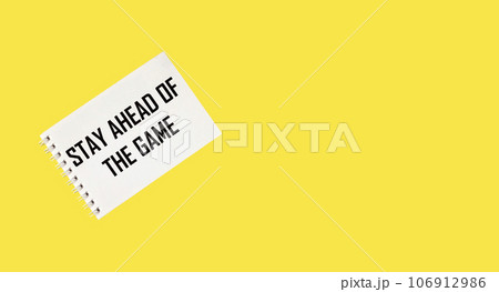 White card with the text Stay Ahead of The Game lies on a yellow background 106912986