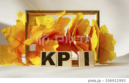 KPI text on a yellow background on wooden cubes 106912993