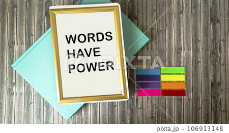 Notepad in a frame with text The words have power lying on a wooden background. 106913148
