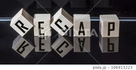 Word RECAP made from wooden blocks on black background 106913223