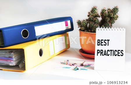 Business term, business phrase. Text on notebook - best practice. Folders, paper clips Business term, business phrase. Text on notebook - best practice. Folders, paper clips 106913234