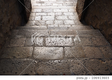 Traditional Paving stone artwork in Herceg Novi Montenegro on roads as well as sidewalks, especially in the old part of town. An old pavement paved with large rectangular stones. Pedestrian zone 106913603