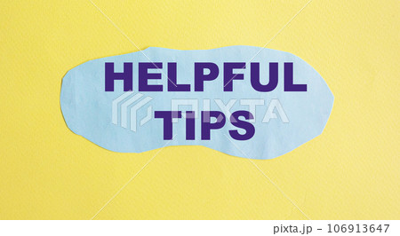 Helpful tips text is written on a blue piece of paper, on a yellow background. 106913647