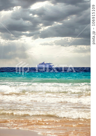 Cruise ship under dramatic sun clouds mix on the sea of atlantic ocean 106915109