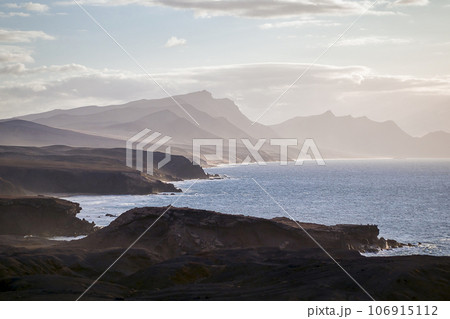The west coast of Fuerteventura in the light fog as seen from the village of La Pared, Canary Islands, Spain 106915112