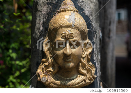 Hindu God Shiva Durga statue attached on cement pillar 106915560