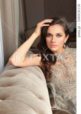 Luxurious glamorous model. Beautiful woman resting in hotel room 106916116