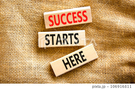 Success starts here symbol. Concept word Success starts here on beautiful wooden block. Beautiful canvas table canvas background. Business motivational success starts here concept. Copy space. Success starts here symbol. Concept word Success starts here on beautiful wooden block. Beautiful canvas table canvas background. Business motivational success starts here concept. Copy space. 106916811